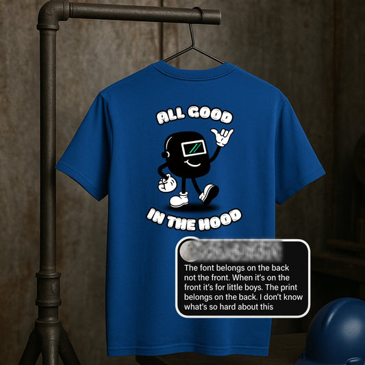 Royal blue t-shirt with a graphic design and text 'All Good in the Hood' on a metallic surface.
